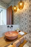 Powder room with terracotta sink and accents, geometric wallpaper Home staging