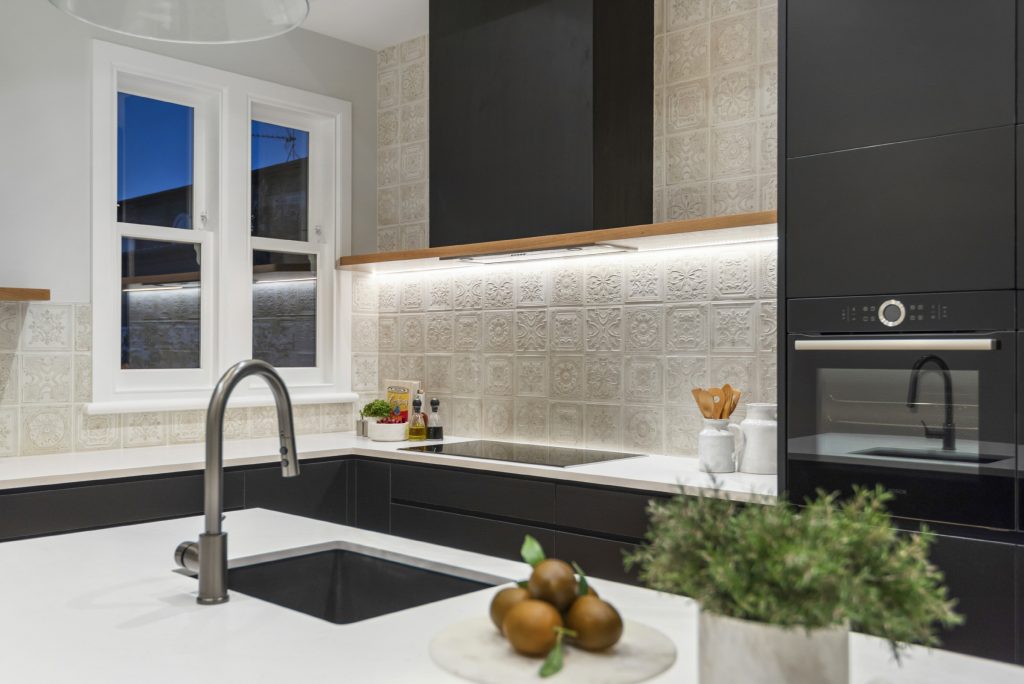 Black kitchen White marble counter tops cream textured tiles Home staging