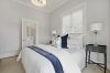 Villa Master bed, Navy and White, Palm lamps Light and bright Home staging