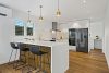 Home staging white kitchen with gold hardware, white Marble counter tops, Gold pendant lights