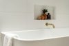 Bath with Gold tap, styled with Rust vase